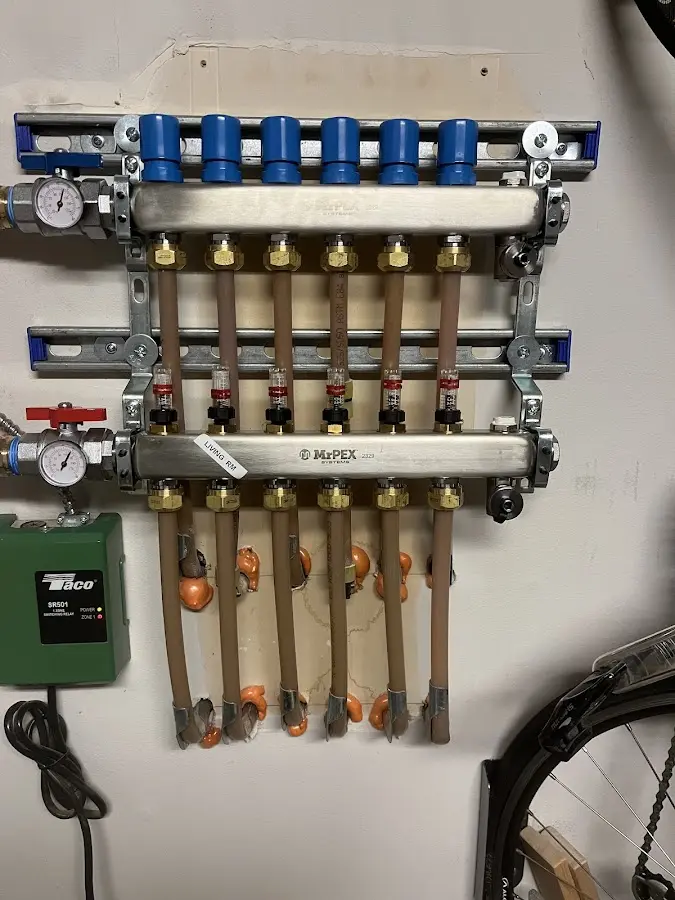 Plumber performing Water Heater Repair at a residential property in Iron River